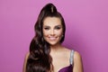 Brunette haired smiling woman portrait with healthy long shiny wavy hairstyle. Volume shampoo. Black curly permed hair