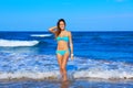Brunette happy girl walking in the beach shore Royalty Free Stock Photo