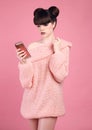 Brunette holding cell telephone. Fashion studio teen look style Royalty Free Stock Photo