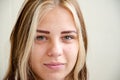 Brunette ith white strands of hair girl looks at camera and smiles. Happy young woman. Beautiful caucasian young girl with green Royalty Free Stock Photo