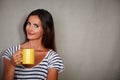 Brunette lady holding mug while looking at camera Royalty Free Stock Photo