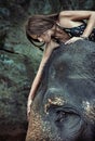 Brunette lady stroking an elephant