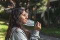 Brunette Latina teen girl removing mask from her face in a park Royalty Free Stock Photo