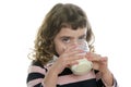 Brunette little girl drinking glass of milk Royalty Free Stock Photo