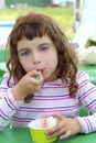 Brunette little girl eating ice cream