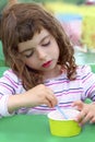 Brunette little girl eating ice cream