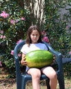 Brunette little girl with a HUGE WATERMELON