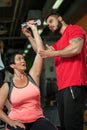 Brunette middle aged woman working out with coach Royalty Free Stock Photo