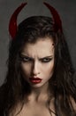 Brunette model with devil horns
