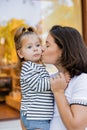 brunette mother kissing baby girl in Royalty Free Stock Photo