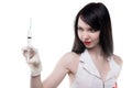 Brunette nurse looking at syringe Royalty Free Stock Photo