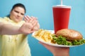 Overweight female denying fast food in her healthy lifestyle Royalty Free Stock Photo