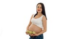 Brunette pregnant future mother with green apples hands smiling on camera isolated on white background