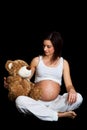 Brunette pregnant woman with teddy Royalty Free Stock Photo