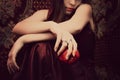 Pensive girl with an apple in her hand. Royalty Free Stock Photo