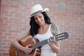 Brunette pretty woman playing a guitar Royalty Free Stock Photo