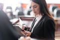 brunette prosecutor reading lawsuit near blurred