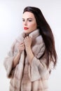 Brunette with red lipstick in light fur coat Royalty Free Stock Photo
