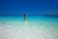 Brunette bikini model posing in sea wave surface, summer ba Royalty Free Stock Photo