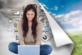 Brunette sitting on floor using laptop