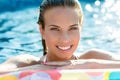 Brunette smiling woman relaxing in pool Royalty Free Stock Photo