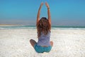 The brunette stretches her arms up, looking at the mountains of Jordan