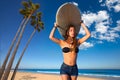 Brunette surfer teen girl holding surfboard in a beach Royalty Free Stock Photo