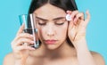 Brunette taking a pill with a glass of water. Woman taking drugs to releave headache. Brunette take some pills, holds Royalty Free Stock Photo