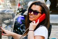 Brunette talking at Public phone box Royalty Free Stock Photo