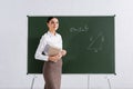 Brunette teacher with book and chalk Royalty Free Stock Photo