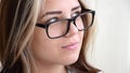 Brunette teen girl with glasses thinks about something. Beautiful caucasian young girl with green eyes looks away.