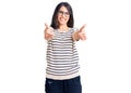 Brunette teenager girl wearing casual clothes and glasses approving doing positive gesture with hand, thumbs up smiling and happy Royalty Free Stock Photo