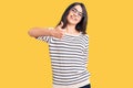 Brunette teenager girl wearing casual clothes and glasses doing happy thumbs up gesture with hand Royalty Free Stock Photo