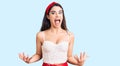 Brunette teenager girl wearing elegant look crazy and mad shouting and yelling with aggressive expression and arms raised Royalty Free Stock Photo