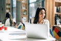 Brunette using laptop in cafe Royalty Free Stock Photo