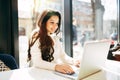 Brunette using laptop in cafe Royalty Free Stock Photo