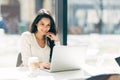 Brunette using laptop in cafe Royalty Free Stock Photo