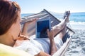 Brunette using tablet while relaxing in the hammock Royalty Free Stock Photo