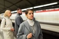 Brunette waiting for train on underground station