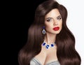 Brunette. wavy hair and jewelry, red lips makeup, long healthy e Royalty Free Stock Photo