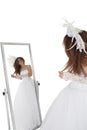 Brunette in wedding gown looking at mirror over white background Royalty Free Stock Photo