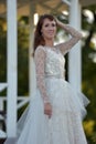 Brunette in a white dress in the park Royalty Free Stock Photo