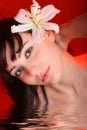 Brunette with white lily flowers in water Royalty Free Stock Photo