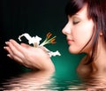 Brunette with white lily flowers in water