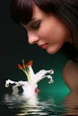 Brunette with white lily flowers in water Royalty Free Stock Photo