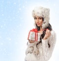 A brunette in winter clothes holding a present Royalty Free Stock Photo