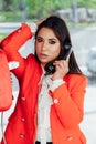 a brunette woman talking on the phone in a booth on the street Royalty Free Stock Photo