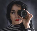 Brunette woman with camera lens in her eye