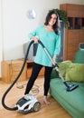 Brunette woman cleaning living room Royalty Free Stock Photo