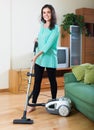 Brunette woman cleaning living room Royalty Free Stock Photo